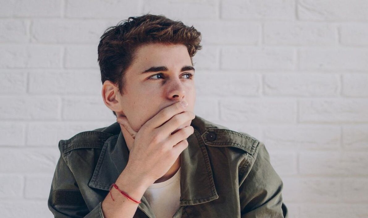A man thinks about ways to enlarge his penis